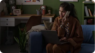 Solopreneur on a call with a laptop, working from a couch